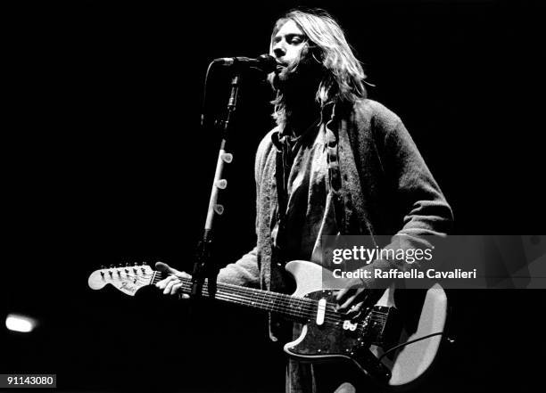 Kurt Cobain performing live onstage at Palasport, Modena, playing Fender Mustang guitar.