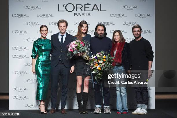 Model Lucia Lopez and designers Juanjo Oliva and Jeff Bargues receive the L'Oreal Paris Award from L'Oreal Paris Brand General Manager Gregory...