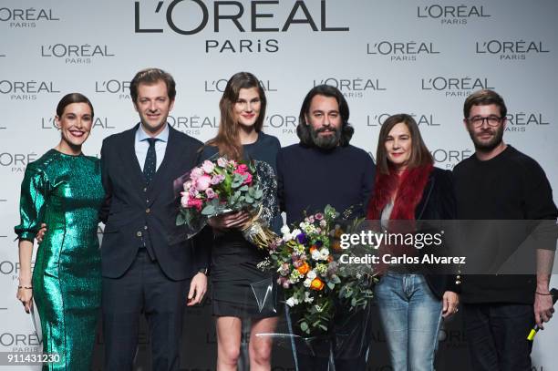 Model Lucia Lopez and designers Juanjo Oliva and Jeff Bargues receive the L'Oreal Paris Award from L'Oreal Paris Brand General Manager Gregory...