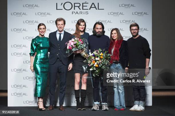 Model Lucia Lopez and designers Juanjo Oliva and Jeff Bargues receive the L'Oreal Paris Award from L'Oreal Paris Brand General Manager Gregory...