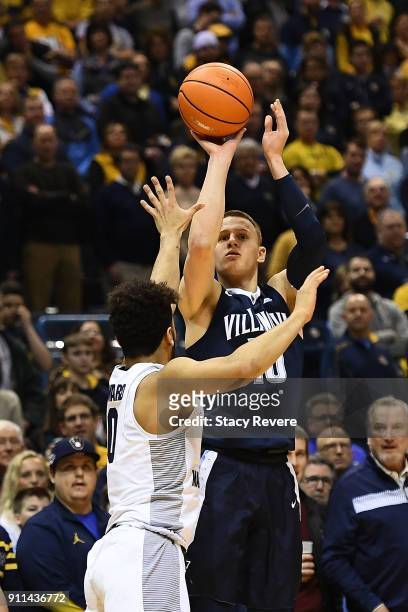 Donte DiVincenzo of the Villanova Wildcats shoots over Markus Howard of the Marquette Golden Eagles during the first half at the BMO Harris Bradley...
