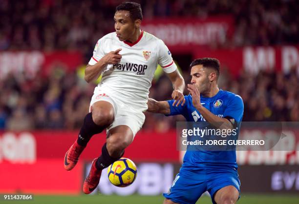 Sevilla's Colombian forward Luis Muriel vies with Getafe's defender Bruno Gonzalez during the Spanish league football match between Sevilla FC and...