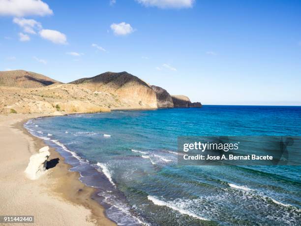 coast line with cliffs and beaches with water waves in movement. cabo de gata - nijar natural park, beach of the white crag, isleta of the moor, biosphere reserve, almeria,  andalusia, spain. - biosphere planet earth stock pictures, royalty-free photos & images