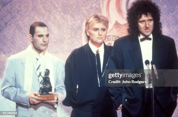 Photo of QUEEN, L- R Freddie Mercury, Roger Taylor and Brian May on stage at the Brit Awards