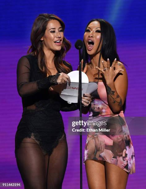 Adult film actress Eva Lovia and adult film actress/director Asa Akira present an award during the 2018 Adult Video News Awards at The Joint inside...