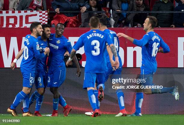 Getafe's forward Angel Luis Rodriguez celebrates a goal with teammates during the Spanish league football match between Sevilla FC and Getafe CF at...