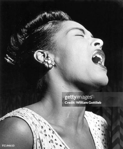 February 1947: Photo of American jazz singer Billie Holiday performing at the Club Downbeat in Manhattan. Bill Gottlieb's picture captures all her...