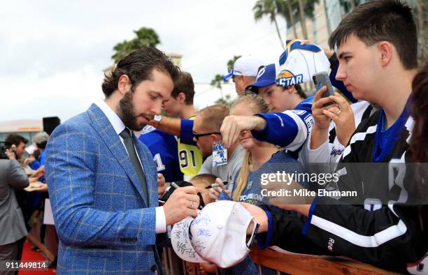 Nikita Kucherov of the Tampa Bay Lightning signs autographs after arriving on the red carpet prior to the 2018 Honda NHL All-Star Game at Amalie...