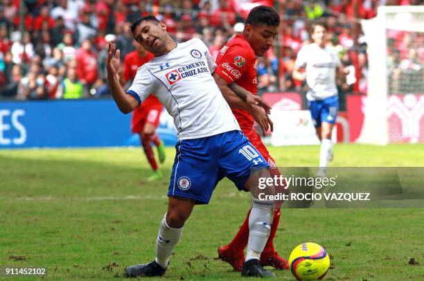 Cruz Azul's Walter Montoya vies for the ball with Toluca's Alexis Vega during the 2018 Mexican Clausura tournament football match at the Nemesio Diez...