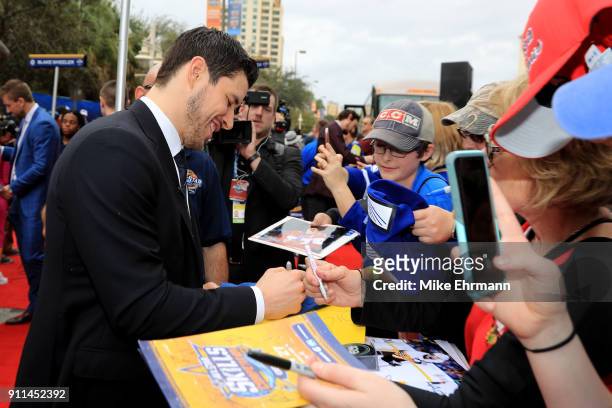 Sidney Crosby of the Pittsburgh Penguins signs autographs aftter arriving on the red carpet prior to the 2018 Honda NHL All-Star Game at Amalie Arena...