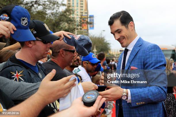 Brian Boyle of the New Jersey Devils signs autographs after arriving on the red carpet prior to the 2018 Honda NHL All-Star Game at Amalie Arena on...