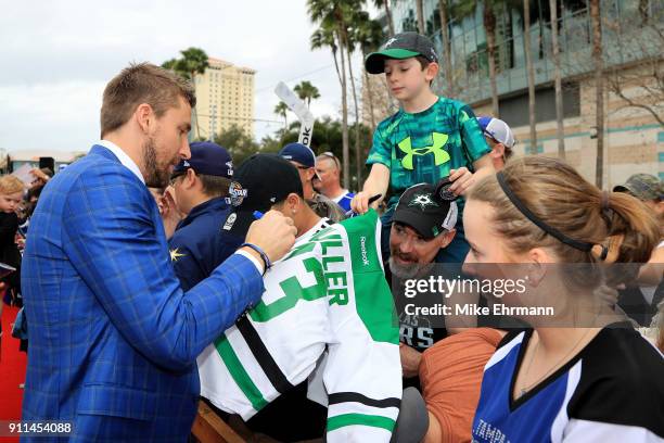 Blake Wheeler of the Winnipeg Jets signs autographs after arriving on the red carpet prior to the 2018 Honda NHL All-Star Game at Amalie Arena on...