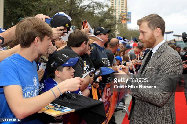 Claude Giroux of the Philadelphia Flyers signs autographs after arriving on the red carpet prior to the 2018 Honda NHL All-Star Game at Amalie Arena...