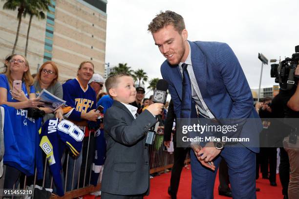 Connor McDavid of the Edmonton Oilers gets interviewed after arriving on the red carpet prior to the 2018 Honda NHL All-Star Game at Amalie Arena on...