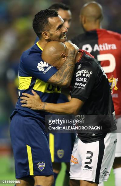 Boca Juniors' forward Carlos Tevez hugs Colon's defender Clemente Rodriguez during their Argentina First Division Superliga football match at La...