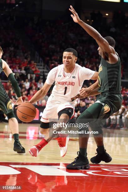 Anthony Cowan of the Maryland Terrapins dribbles by Lourawls Nairn Jr. #11 of the Michigan State Spartans during a college basketball game at The...