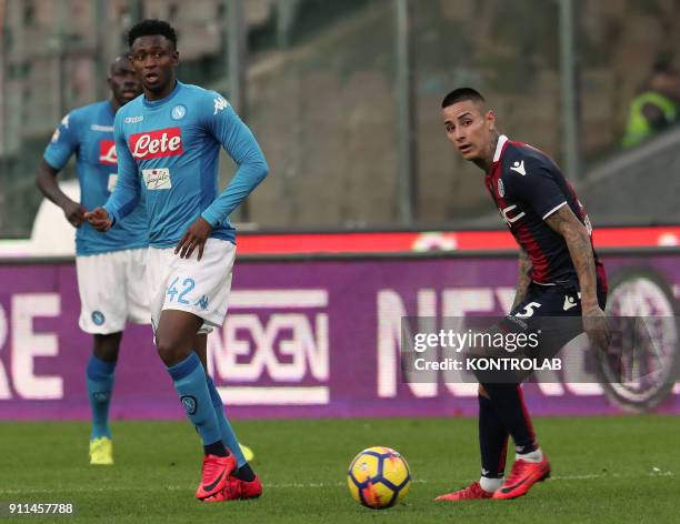 Napoli's Guinean midfielder Amadou Diawara looks on next to Bologna's Chilean midfielder Erick Pulgar during the Italian Serie A football match SSC...