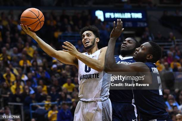 Markus Howard of the Marquette Golden Eagles is defended by Dhamir Cosby-Roundtree of the Villanova Wildcats during the second half at the BMO Harris...