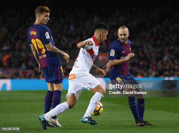 Lucas Digne of Barcelona , Hernan Perez of Alaves and Andres Iniesta of Barcelona battle for posession during the La Liga match between Barcelona and...