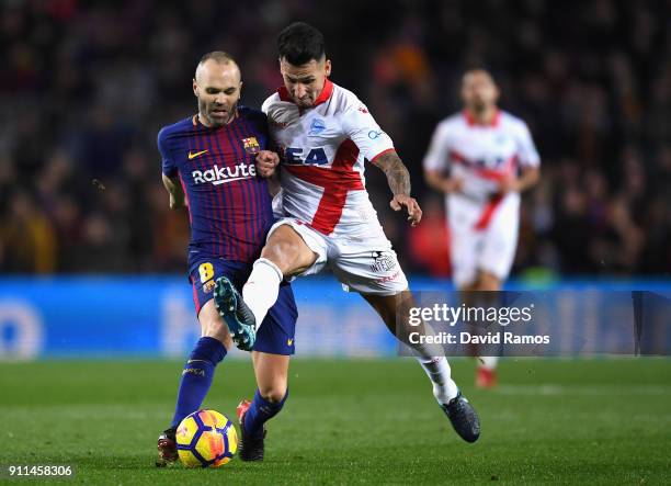 Andres Iniesta of Barcelona is tackled by Hernan Perez of Alaves during the La Liga match between Barcelona and Deportivo Alaves at Camp Nou on...