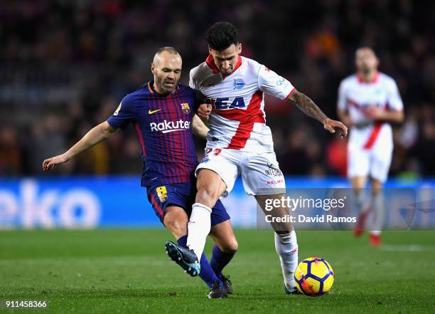 Andres Iniesta of Barcelona is tackled by Hernan Perez of Alaves during the La Liga match between Barcelona and Deportivo Alaves at Camp Nou on...