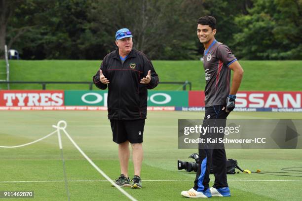 Head Coach Andy Moles of Afghanistan and Naveen Ul Haq of Afghanistan look on prior to the ICC U19 Cricket World Cup Semi Final match between...