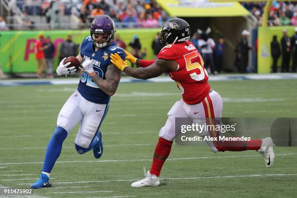 Terrell Suggs of the Baltimore Ravens pushes Kyle Rudolph of the Minnesota Vikings out of bounds during the NFL Pro Bowl between the AFC and NFC at...