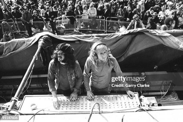 Photo of FESTIVALS, sound engineers at mixing desk, mixing sound at Weeley Festival, with crowds in audience behind, hippies, festivals