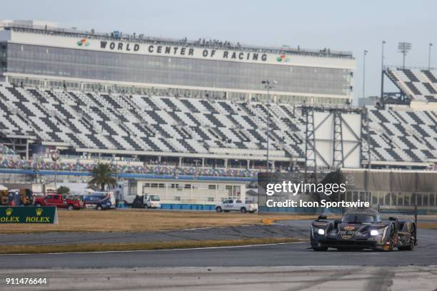 The Mustang Sampling Racing Cadillac DPi-V.R. Of Filipe Albuquerque, Joao Barbosa and Christian Fittipaldi races into a turn during the Rolex 24 at...