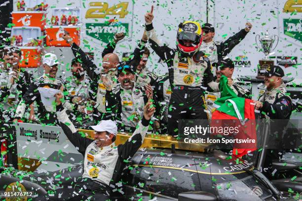 Filipe Albuquerque, driver of the Mustang Sampling Racing Cadillac DPi-V.R. Celebrates with teammates in Victory Lane following the Rolex 24 at...