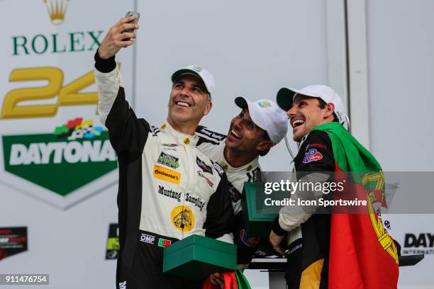 Joao Barbosa, driver of the Mustang Sampling Racing Cadillac DPi-V.R. Takes a selfie in Victory Lane with teammates Filipe Albuquerque and Christian...