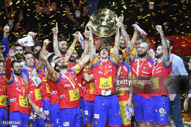 Spain's Viran Morros de Argila holds the EHF European Handball Championship trophy as Spain's players celebrate during the podium ceremony, after...