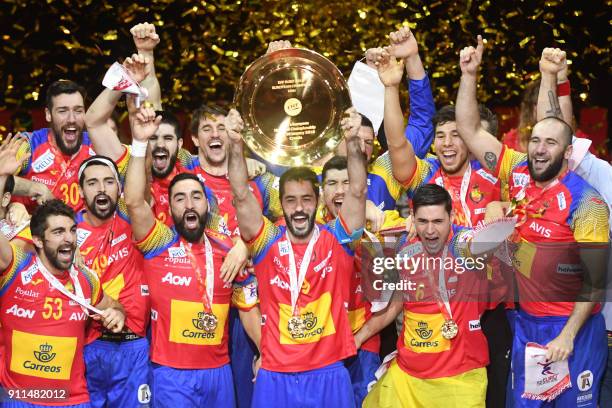 Spain's Raul Entrerrios holds EHF European Handball Championship trophy as Spain's players celebrate during the podium ceremony, after winning the...