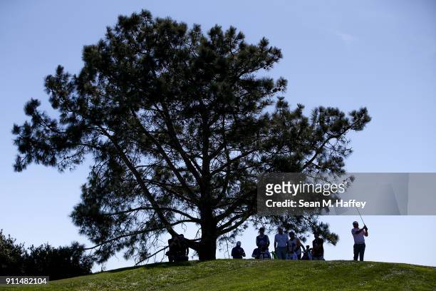 Holmes plays his shot from the sixth tee during the final round of the Farmers Insurance Open at Torrey Pines South on January 28, 2018 in San Diego,...