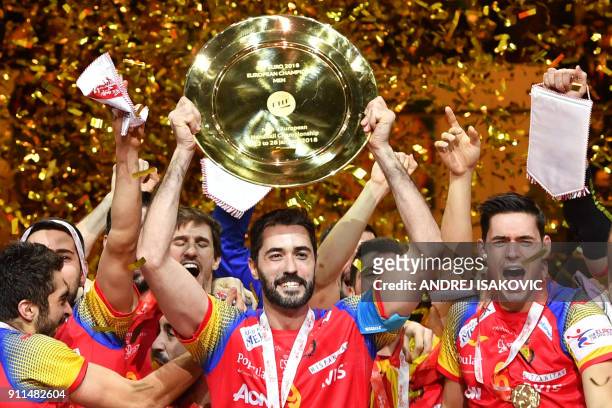 Spain's Raul Entrerrios holds EHF European Handball Championship trophy as Spain's players celebrate during the podium ceremony, after winning the...