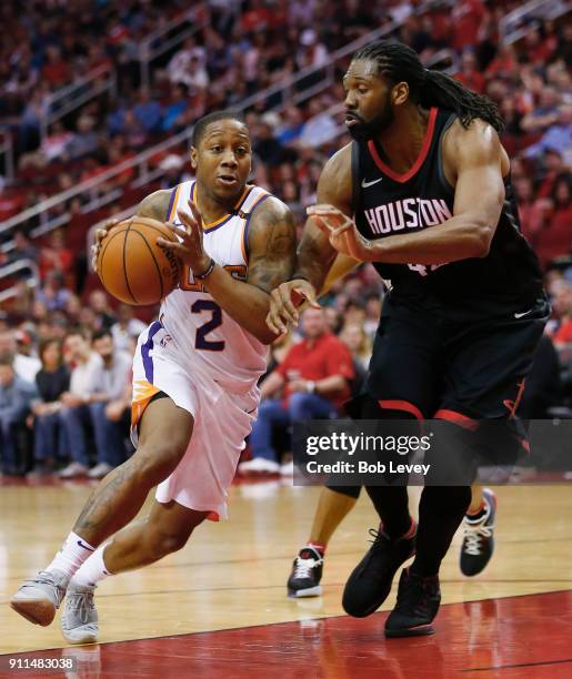 Isaiah Canaan of the Phoenix Suns drives on Nene Hilario of the Houston Rockets at Toyota Center on January 28, 2018 in Houston, Texas. NOTE TO USER:...