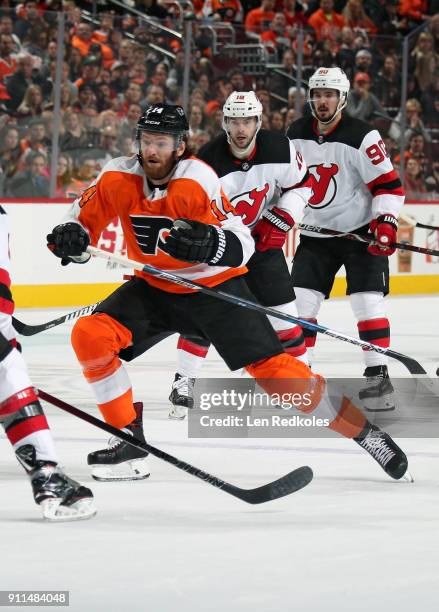 Sean Couturier of the Philadelphia Flyers in action against Drew Stafford and Marcus Johansson of the New Jersey Devils on January 20, 2018 at the...