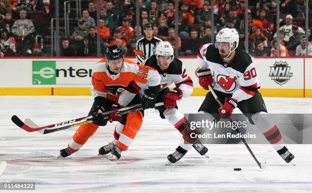 Marcus Johansson of the New Jersey Devils skates the puck as Damon Severson defends Jordan Weal of the Philadelphia Flyers on January 20, 2018 at the...