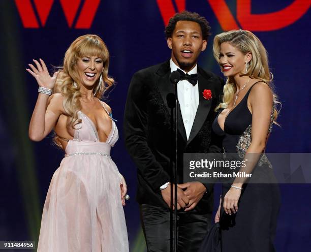 Adult film actress Cherie DeVille, adult film actor Ricky Johnson and adult film actress Jessa Rhodes present an award during the 2018 Adult Video...