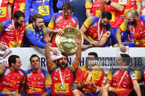 Spain's David Balaguer reacts as Spain's Viran Morros de Argila holds EHF European Handball Championship trophy while Spain's players celebrate...