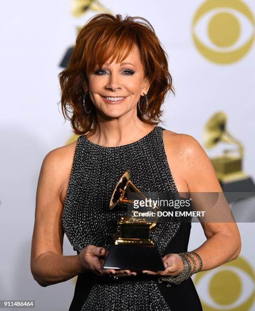 Recording artist Reba McEntire, winner of the Best Roots Gospel Album award for 'Sing It Now: Songs of Faith & Hope,' poses in the press room during...