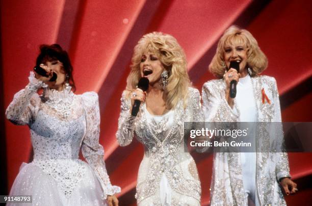Photo of Tammy Wynette, Loretta Lynn and Dolly Parton performing together, circa 1980.