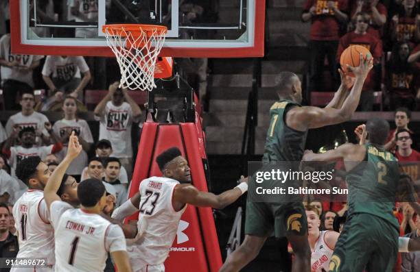 Michigan State's Joshua Langford grabs an offensive rebound over Maryland's Jared Nickens, from left, Anthony Cowan Jr., and Bruno Fernando in the...