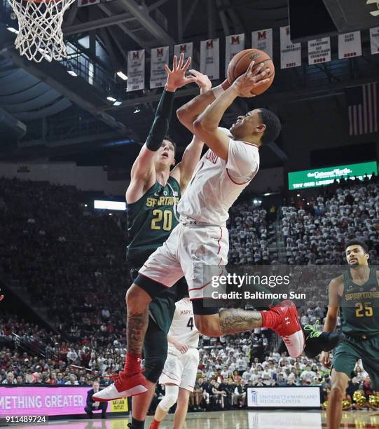 Maryland's Anthony Cowan Jr., right, is fouled by Michigan State's Matt McQuaid on the way to the basket in the second half on Sunday, Jan. 28, 2018...