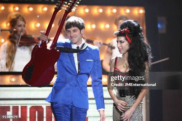 Photo of Mark RONSON and Amy WINEHOUSE, Mark Ronson performing on stage with Amy Winehouse, twin necked guitar