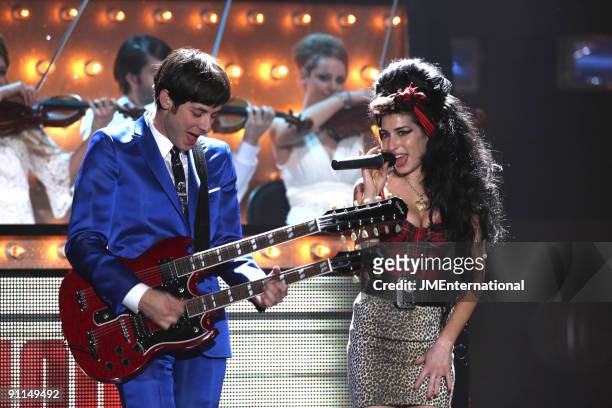 Photo of Mark RONSON and Amy WINEHOUSE, Mark Ronson performing on stage with Amy Winehouse, twin necked guitar