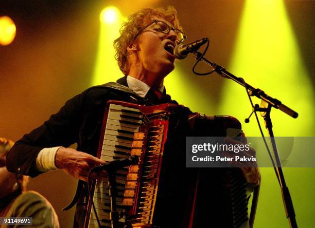 Photo of ARCADE FIRE, Arcade Fire, Nederland, Lowlands,, Biddinghuizen, 20 augustus 2005, Pop, indie, de accordeonist speelt tegen een achtergrond...