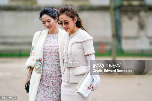 Guest wears a tweed white jacket, a white Chanel bag, outside Chanel, during Paris Fashion Week -Haute Couture Spring/Summer 2018, on January 23,...