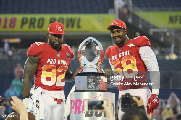 Game MVP honorees Delanie Walker of the Tennessee Titans and Von Miller of the Denver Broncos celebrate onstage after winning the NFL Pro Bowl...