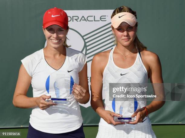 Danielle Collins holds the women's championship trophy and Sofya Zhuk holds the runner up trophy after a three set finals match played at the Oracle...